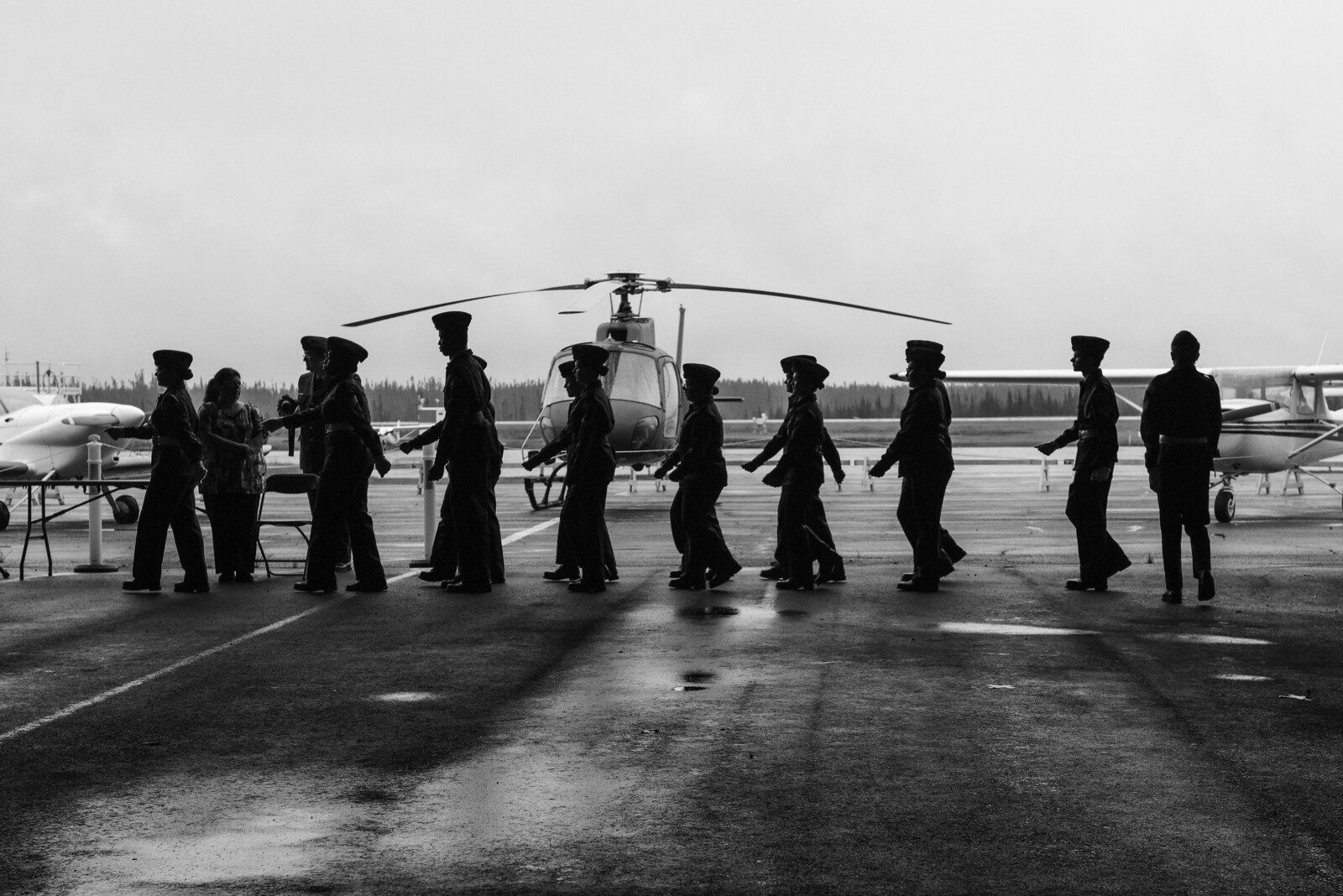 Des membres de l’escadron participent à une parade sur un aérodrome.